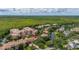 Aerial view of a multi-story condo surrounded by lush greenery and a beautiful stream at 502 Mirasol Cir # 103, Kissimmee, FL 34747