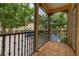 Spacious balcony with wood-look tile overlooking the neighborhood with mature trees and parking at 502 Mirasol Cir # 103, Kissimmee, FL 34747