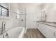 Bright bathroom with a glass-enclosed shower, soaking tub, double vanity, and marble countertops at 502 Mirasol Cir # 103, Kissimmee, FL 34747