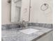 Close-up of marble vanity, sink and mirror in bathroom with neutral colors at 502 Mirasol Cir # 103, Kissimmee, FL 34747