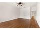 A neutral bedroom with hardwood floors, a ceiling fan, and two closet doors at 502 Mirasol Cir # 103, Kissimmee, FL 34747