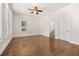 Spacious bedroom with hardwood floors, ceiling fan, and natural light streaming through windows at 502 Mirasol Cir # 103, Kissimmee, FL 34747