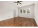 Bright bedroom with hardwood floors, white trim, a ceiling fan and white window shutters at 502 Mirasol Cir # 103, Kissimmee, FL 34747