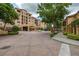 Scenic view of the entrance of condo complex with fountains and well maintained landscape at 502 Mirasol Cir # 103, Kissimmee, FL 34747
