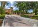 Elegant entrance to Mirasol Private Residences with landscaped brick-paved drive and signage at 502 Mirasol Cir # 103, Kissimmee, FL 34747