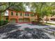 Two-story Mediterranean-style home with a two-car garage, mature trees and shrubs at 502 Mirasol Cir # 103, Kissimmee, FL 34747