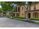 Beautiful two-story home with a tile roof, balcony, arched windows and mature landscaping at 502 Mirasol Cir # 103, Kissimmee, FL 34747