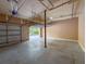 A spacious garage with concrete floors, open garage door and high ceilings at 502 Mirasol Cir # 103, Kissimmee, FL 34747
