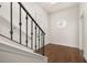 Inviting hallway with hardwood floors, staircase and round window letting in natural light at 502 Mirasol Cir # 103, Kissimmee, FL 34747