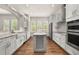 Bright kitchen with white cabinets, stainless steel appliances, island, and plenty of counter space at 502 Mirasol Cir # 103, Kissimmee, FL 34747