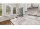 Close-up view of a kitchen with granite countertops, stainless steel fridge, and open shelving at 502 Mirasol Cir # 103, Kissimmee, FL 34747