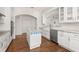 Spacious kitchen features granite countertops, stainless steel appliances, island, and hardwood floors at 502 Mirasol Cir # 103, Kissimmee, FL 34747