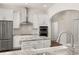 Modern white kitchen with stainless steel appliances, marble countertops, and subway tile backsplash at 502 Mirasol Cir # 103, Kissimmee, FL 34747