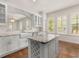 Bright kitchen features a center island with wine rack, farmhouse sink, and marble countertops at 502 Mirasol Cir # 103, Kissimmee, FL 34747