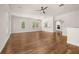 Spacious living room featuring hardwood floors, large windows, and an open view to the kitchen at 502 Mirasol Cir # 103, Kissimmee, FL 34747