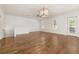 Bright living room featuring hardwood floors, white shiplap wall, and modern light fixture at 502 Mirasol Cir # 103, Kissimmee, FL 34747