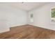 Bright living room with hardwood floors, shiplap wall, and plantation shutters on the windows at 502 Mirasol Cir # 103, Kissimmee, FL 34747
