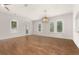 Light-filled living room with hardwood floors, windows and a decorative pendant light at 502 Mirasol Cir # 103, Kissimmee, FL 34747