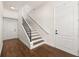 Elegant staircase with hardwood floors, white risers, and iron railing at 502 Mirasol Cir # 103, Kissimmee, FL 34747