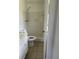Bathroom features shower with white tiling and a standard toilet at 5449 Nw 2Nd St, Ocala, FL 34482