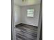Cozy bedroom with modern vinyl flooring and a view of the outside neighborhood at 5449 Nw 2Nd St, Ocala, FL 34482