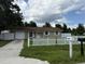 Charming single-story home featuring a driveway, white picket fence, and well-manicured lawn at 5449 Nw 2Nd St, Ocala, FL 34482