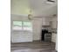 Bright kitchen with white cabinets, modern appliances, and wood-look vinyl flooring at 5449 Nw 2Nd St, Ocala, FL 34482
