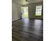 Bright and airy living room with dark laminate flooring, freshly painted walls, and a large window at 5449 Nw 2Nd St, Ocala, FL 34482