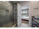 Contemporary bathroom with a glass shower enclosure adjoining a bedroom view at 5573 Torino Rd, Kissimmee, FL 34746