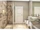 Elegant bathroom showcasing a glass-enclosed shower, dual sinks, and marble accents at 5573 Torino Rd, Kissimmee, FL 34746