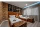 Comfortable bedroom featuring twin beds with exposed brick and unique artwork at 5573 Torino Rd, Kissimmee, FL 34746