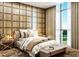 Beautifully designed bedroom with wood paneling and large window providing natural light at 5573 Torino Rd, Kissimmee, FL 34746
