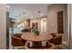 Cozy dining area with warm tones, modern lighting, and views of the kitchen, perfect for intimate gatherings at 5573 Torino Rd, Kissimmee, FL 34746