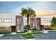 Striking townhome exterior with palm tree and modern landscaping enhances curb appeal, set against a serene sky at 5573 Torino Rd, Kissimmee, FL 34746