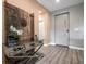 Stylish foyer with rustic door decor, modern console table, and contemporary lighting at 5573 Torino Rd, Kissimmee, FL 34746