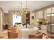 Modern kitchen with sleek island, stainless steel appliances, and pendant lighting offers style and functionality at 5573 Torino Rd, Kissimmee, FL 34746