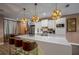 Bright kitchen featuring a large island with seating, stainless steel appliances, and modern pendant lighting, creating a stylish space at 5573 Torino Rd, Kissimmee, FL 34746