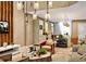 Stylish living area with a modern design, warm lighting, and an open concept flowing seamlessly into the kitchen space at 5573 Torino Rd, Kissimmee, FL 34746