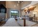 Bright living room with high ceilings, wooden world map decor, and sliding glass doors to patio at 5573 Torino Rd, Kissimmee, FL 34746