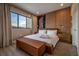 Bright main bedroom boasts a contemporary design, wood-paneled wall, and natural light at 5573 Torino Rd, Kissimmee, FL 34746