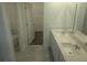 Bathroom with double sink vanity, stone countertop, and access to closet and toilet room at 5793 Gingham Dr, Kissimmee, FL 34758