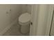 Bathroom featuring a modern white toilet and gray tile floors at 5793 Gingham Dr, Kissimmee, FL 34758