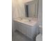 Bright bathroom features double sinks, white cabinetry, neutral countertop and tile flooring at 5793 Gingham Dr, Kissimmee, FL 34758