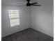 The bedroom features carpet, neutral walls, a ceiling fan, and a window with blinds at 5793 Gingham Dr, Kissimmee, FL 34758