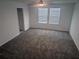 Bright bedroom with natural light, neutral carpet, and ceiling fan at 5793 Gingham Dr, Kissimmee, FL 34758