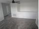 Bonus room featuring gray carpet, a modern ceiling fan, and access to multiple rooms at 5793 Gingham Dr, Kissimmee, FL 34758