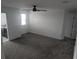 Spacious bonus room with gray carpet, a modern ceiling fan, and access to multiple rooms at 5793 Gingham Dr, Kissimmee, FL 34758