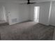 Well-lit bonus room featuring gray carpet, a modern ceiling fan, and multiple doors at 5793 Gingham Dr, Kissimmee, FL 34758