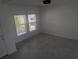 Bright empty room with tile floors and large windows at 5793 Gingham Dr, Kissimmee, FL 34758