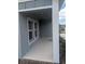 Charming front porch area with white trim windows, great for relaxing outdoors at 5793 Gingham Dr, Kissimmee, FL 34758